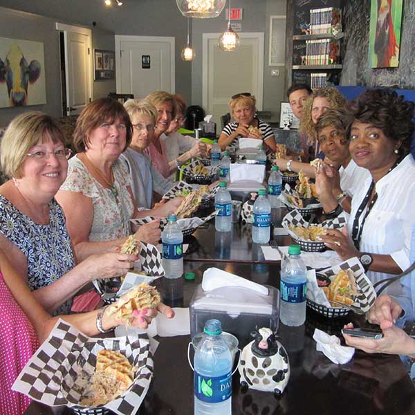 group sitting at large table actively eating